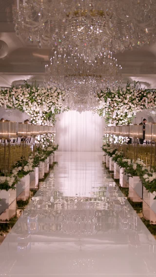 Mirrored aisle beneath crystal chandeliers